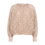 Beige bluse med lyse broderede prikker, ballonform og høje manchetter set forfra
