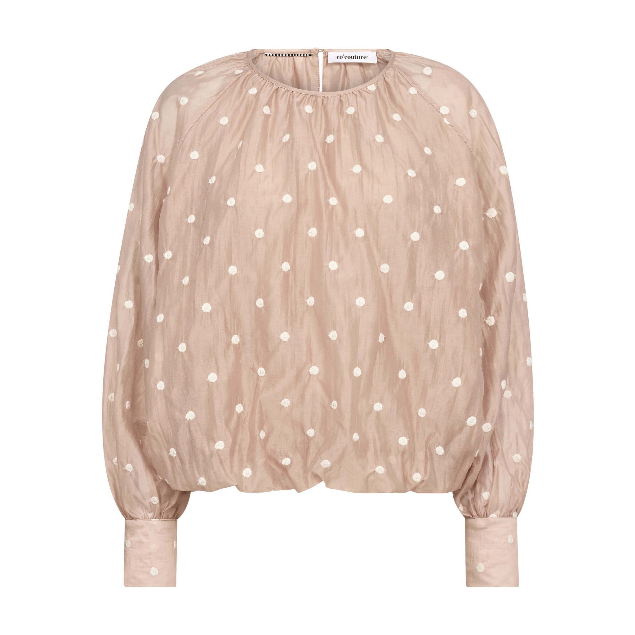 Beige bluse med lyse broderede prikker, ballonform og høje manchetter set forfra