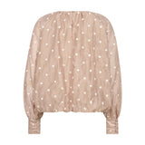 Beige ballonbluse med prikker set bagfra med knapper på de høje manchetter
