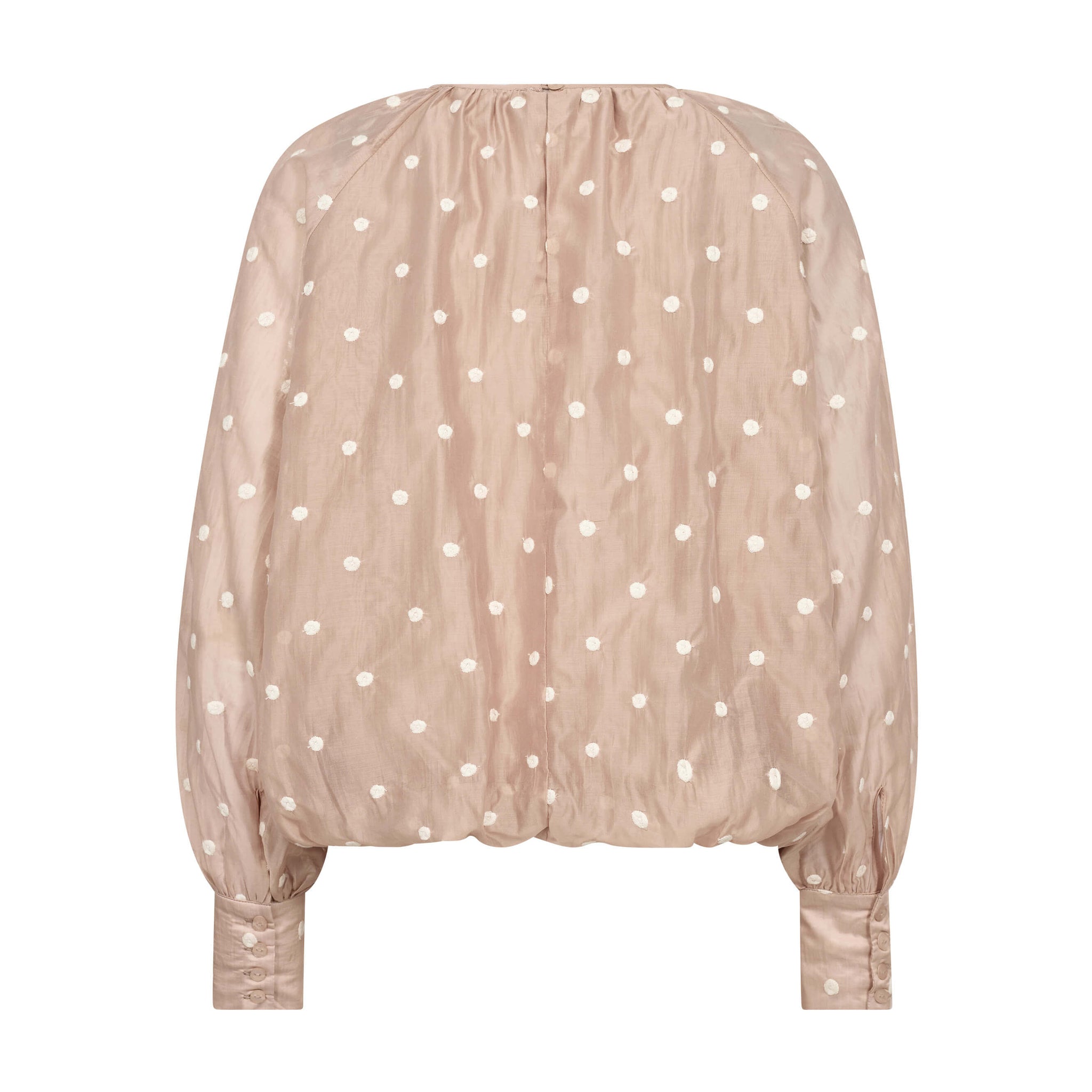 Beige ballonbluse med prikker set bagfra med knapper på de høje manchetter