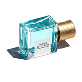 Pacific Rock Moss parfume 50 ml liggende på siden med etiketten vendt opad og låget med træstruktur