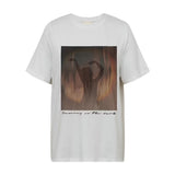 Hvid t-shirt fra Gossia forfra med fotoprint af dansende silhuet og teksten Dancing in the dark