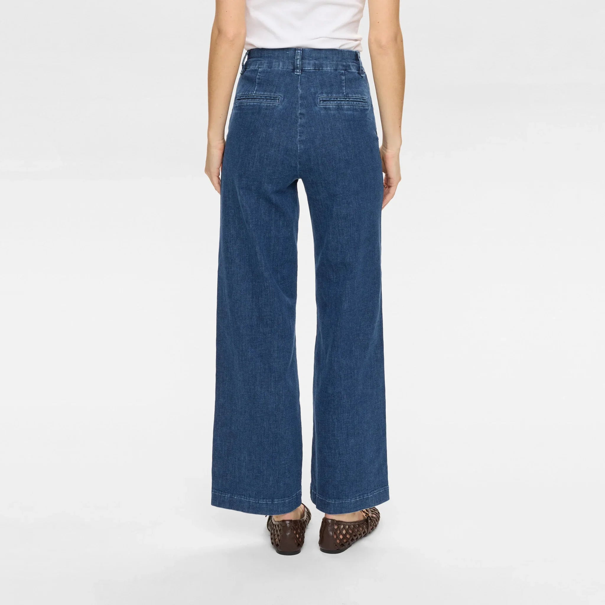Model i blå wide leg jeans med høj talje set bagfra