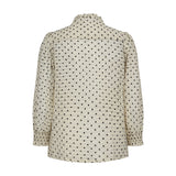 Hvid skjorte med små sorte blomster og smock ved håndleddet, set bagfra
