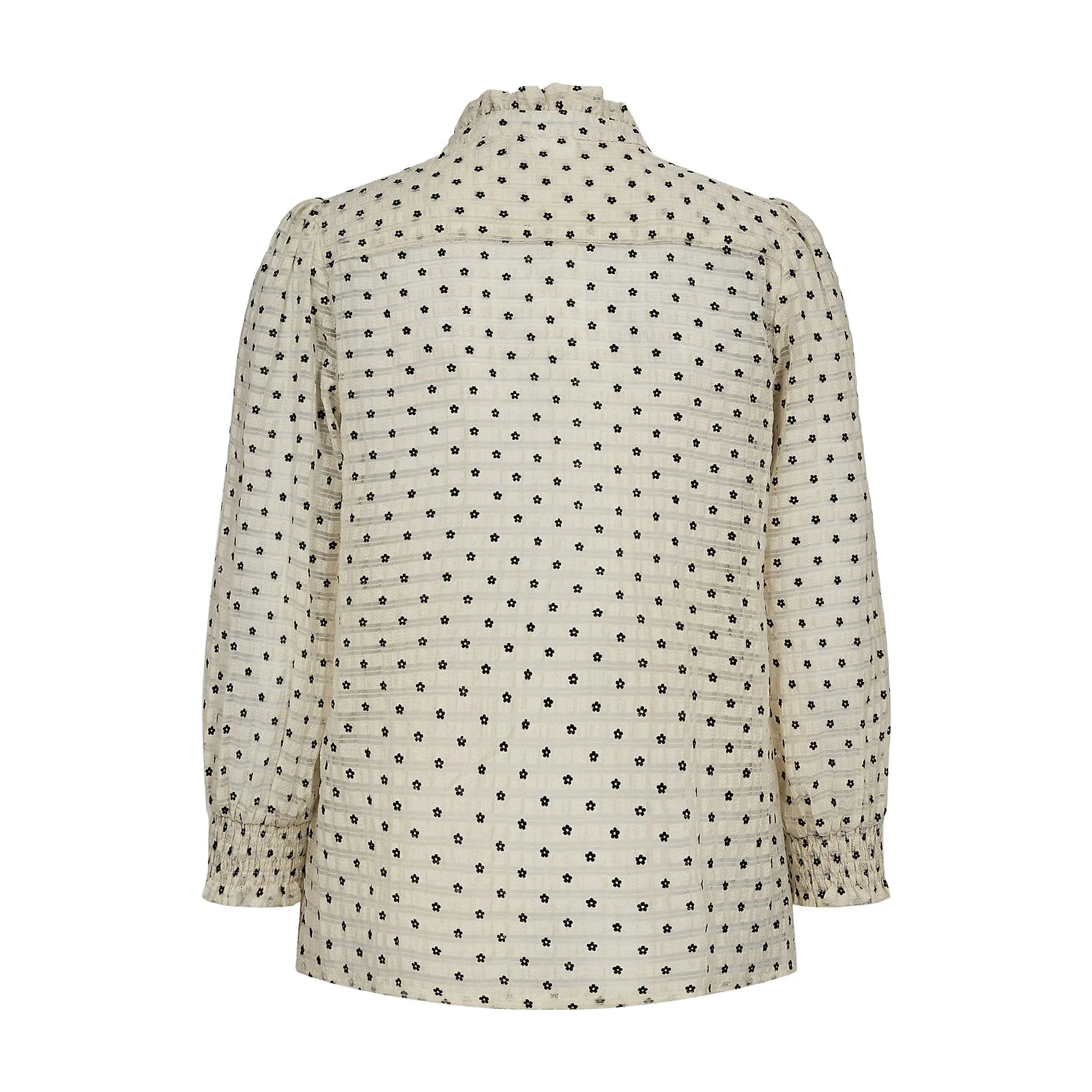 Hvid skjorte med små sorte blomster og smock ved håndleddet, set bagfra