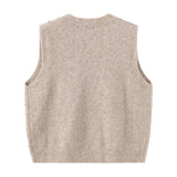 Beige vest i strik set bagfra med glat ryg og ribkant forneden