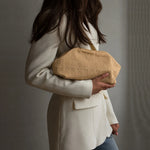 Model holder beige Rosalia Clutch taske med hulmønster under armen