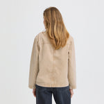 Model i beige jakke fra Pulz med mørke jeans, set bagfra