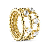 Crystal Ring i guld fra Wolff Jewelry med tre kuglerækker og klare runde sten, set fra siden på lys baggrund