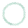 Mintgrønt elastisk armbånd med runde naturlige stenperler fra Wolff Jewelry set ovenfra på hvid baggrund