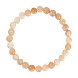 Orange Jalle perlearmbånd i Peach fra Wolff Jewelry med runde stenperler i lyse ferskentoner, set ovenfra