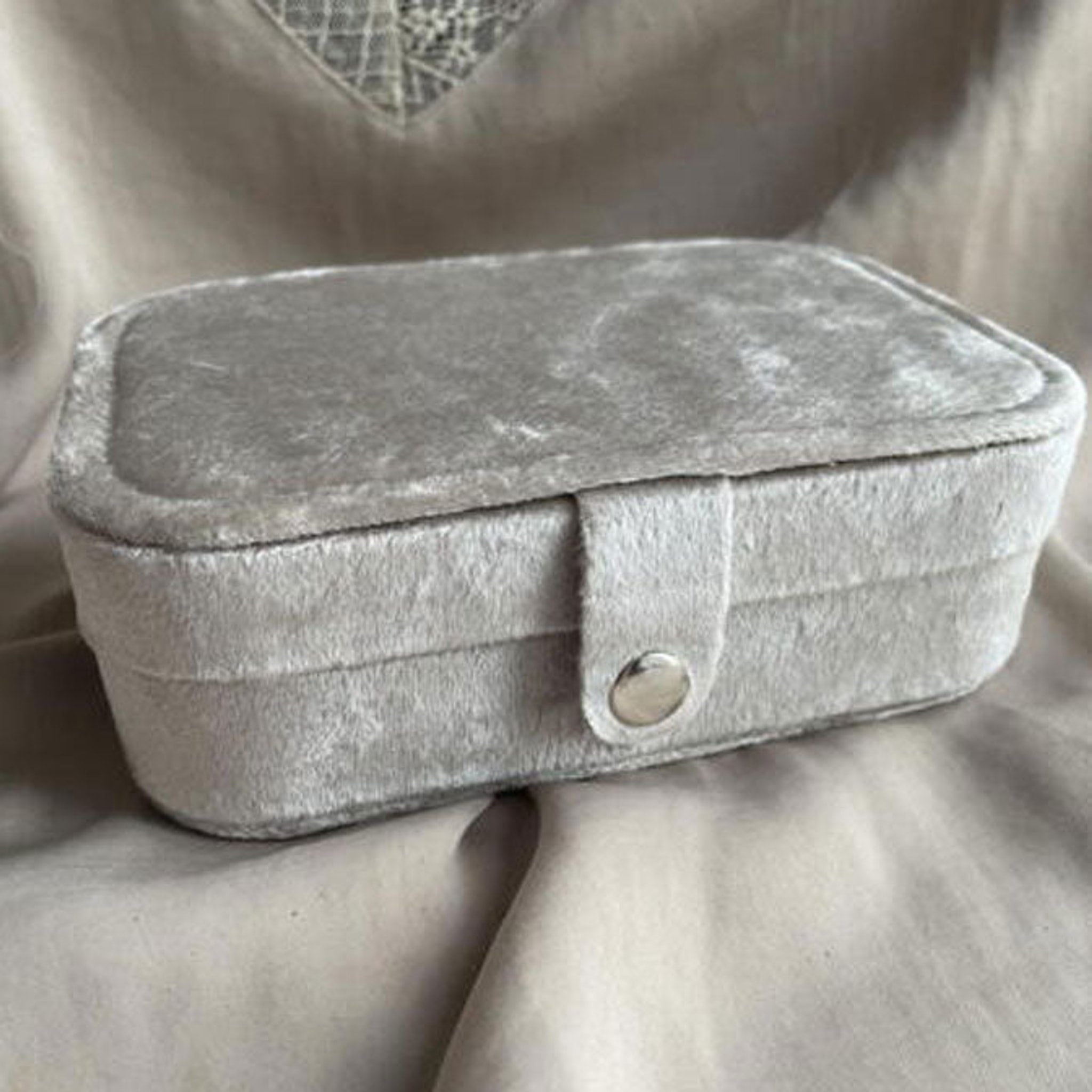 Beige smykkeskrin Jewely Oblong Box fra Wolff Jewelry, aflangt med låg og strop med sølvfarvet trykknap