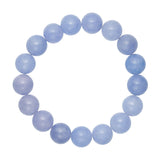 Blåt armbånd i Ice Blue fra Wolff Jewelry med runde perler af natursten, set ovenfra på lys baggrund