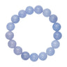 Blåt armbånd i Ice Blue fra Wolff Jewelry med runde perler af natursten, set ovenfra på lys baggrund