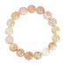 Pink Jusi Pearl Bracelet fra Wolff Jewelry med runde perler af natursten i rosa, fersken og creme, set ovenfra