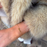 Guldfarvet Luna Love armbånd med love-skrift båret om håndleddet