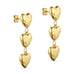 Rustic Heart ørering i guld fra Wolff Jewelry med tre hængende hjerter, set skråt fra siden på lys baggrund