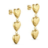 Rustic Heart ørering i guld fra Wolff Jewelry med tre hængende hjerter, set skråt fra siden på lys baggrund