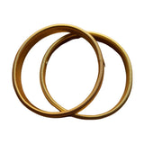 To guldfarvede sleeve holders fra Wolff Jewelry med riflet spiralstruktur lagt over hinanden på hvid baggrund