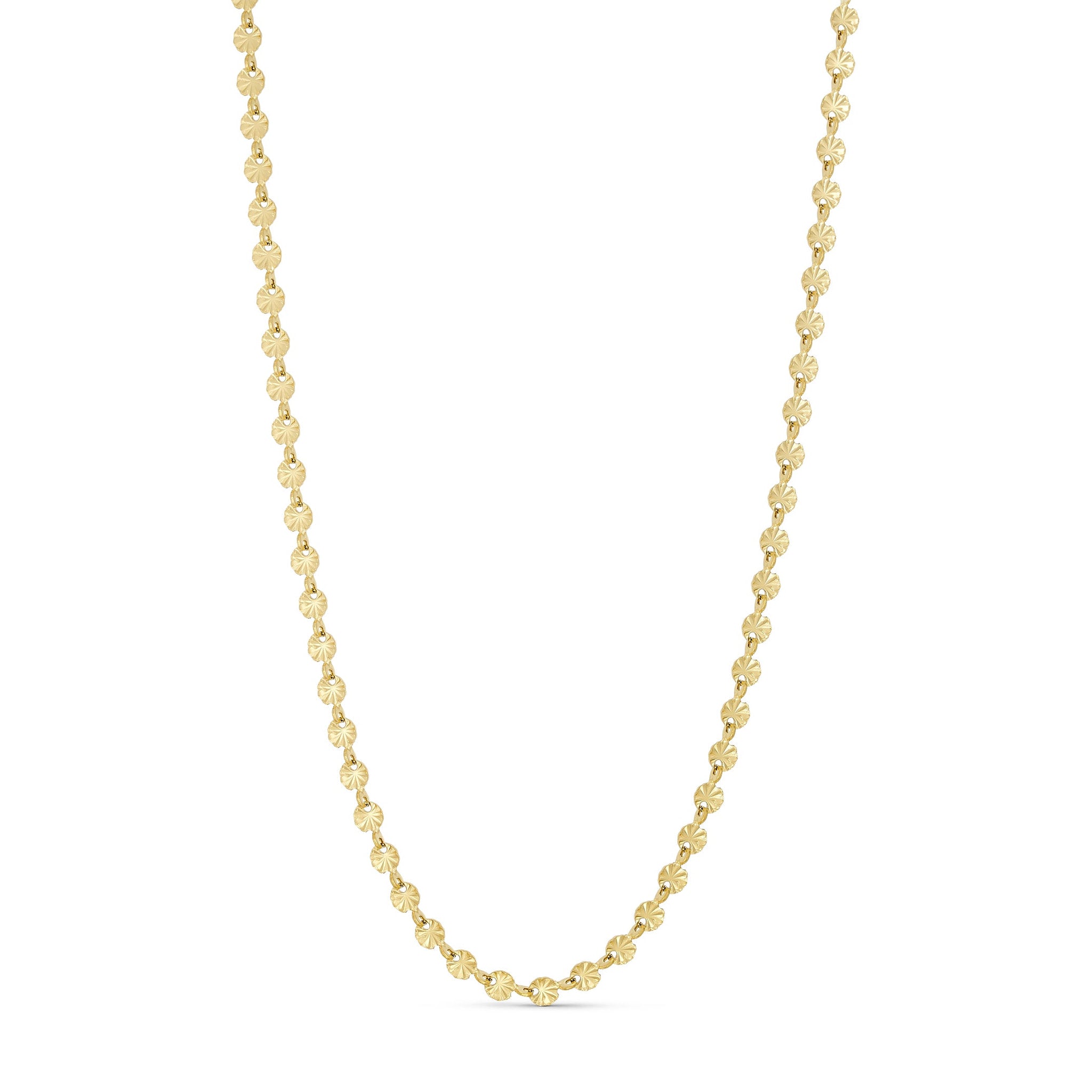 Sunny Chain Necklace halskæde i guld fra Wolff Jewelry med små runde led med strålemønster på lys baggrund